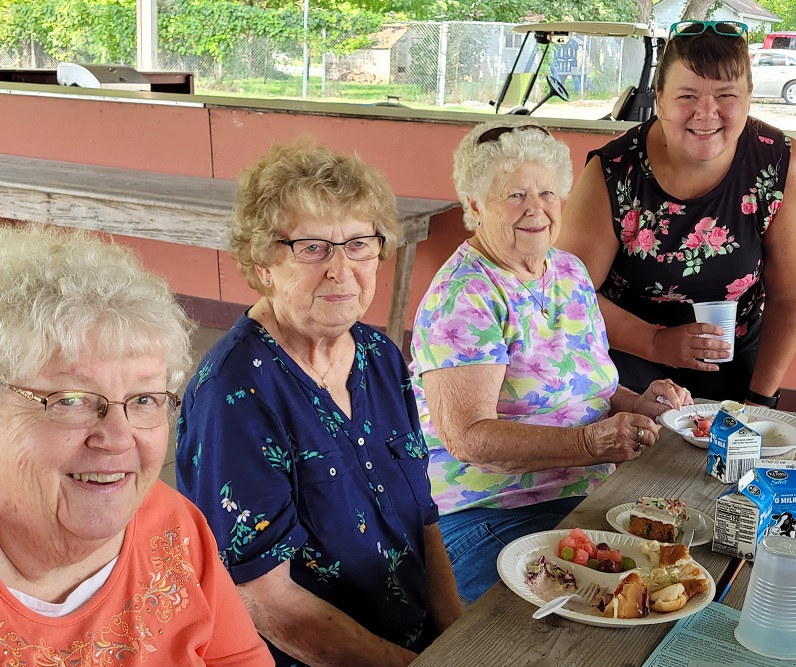 Participants sharing a meal and conversation at an ADVOCAP congregate meal site.