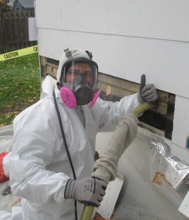 ADVOCAP Weatherization staff member insulating the exterior of a home